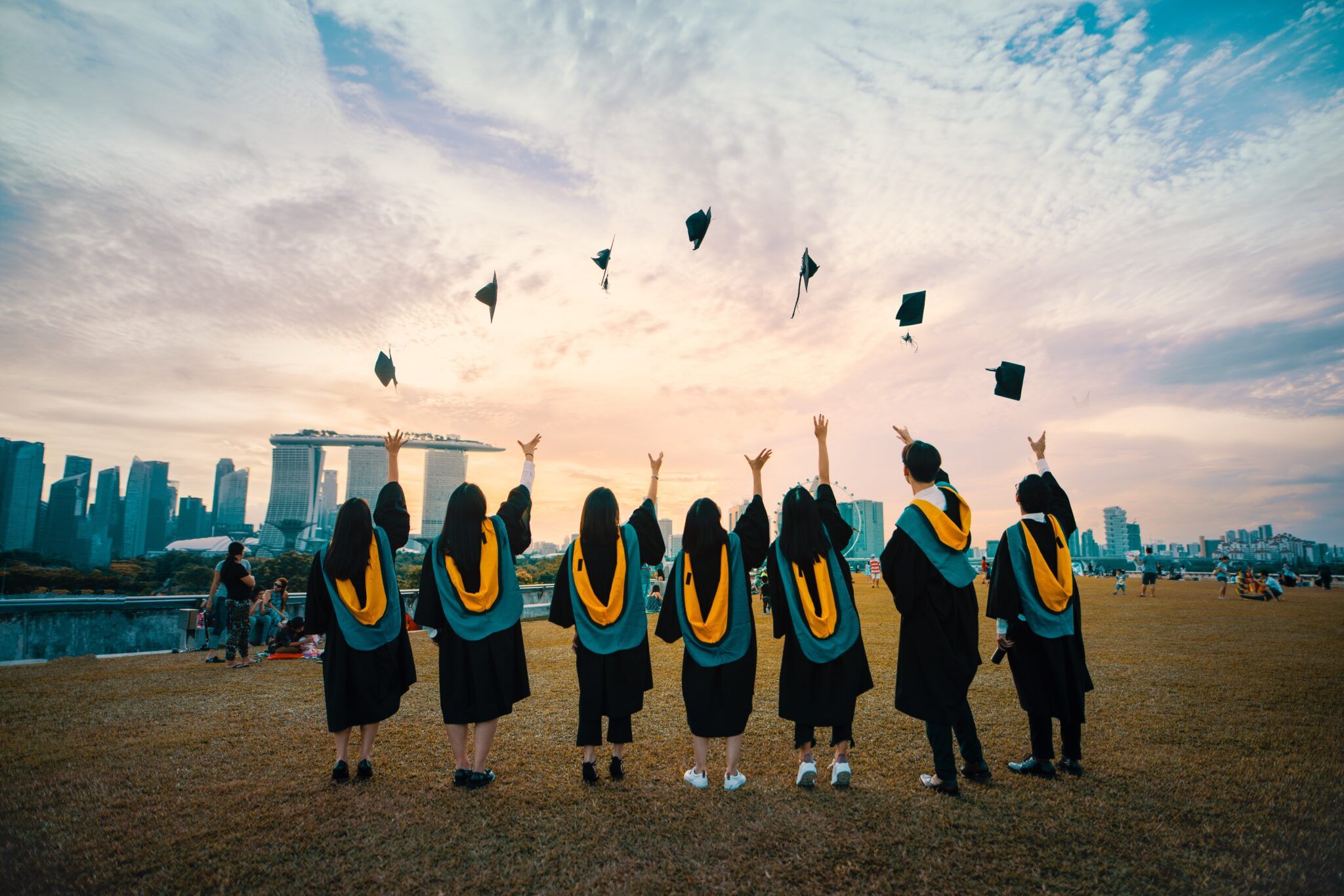 Students graduating and throwing their caps into the air