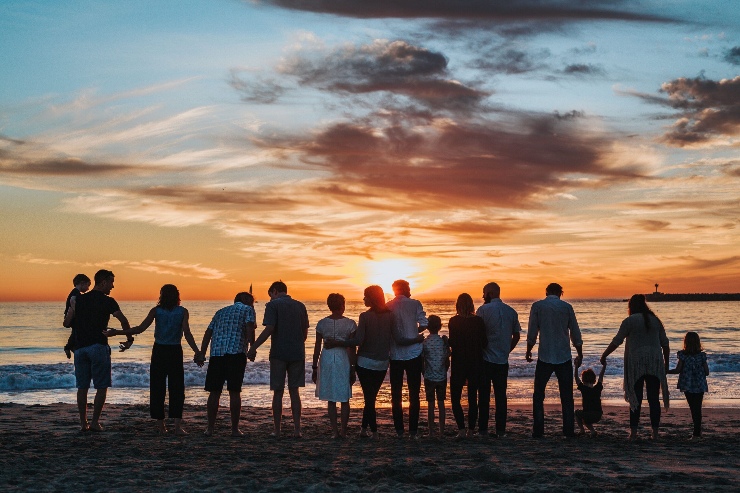 group photo on beach at sunset