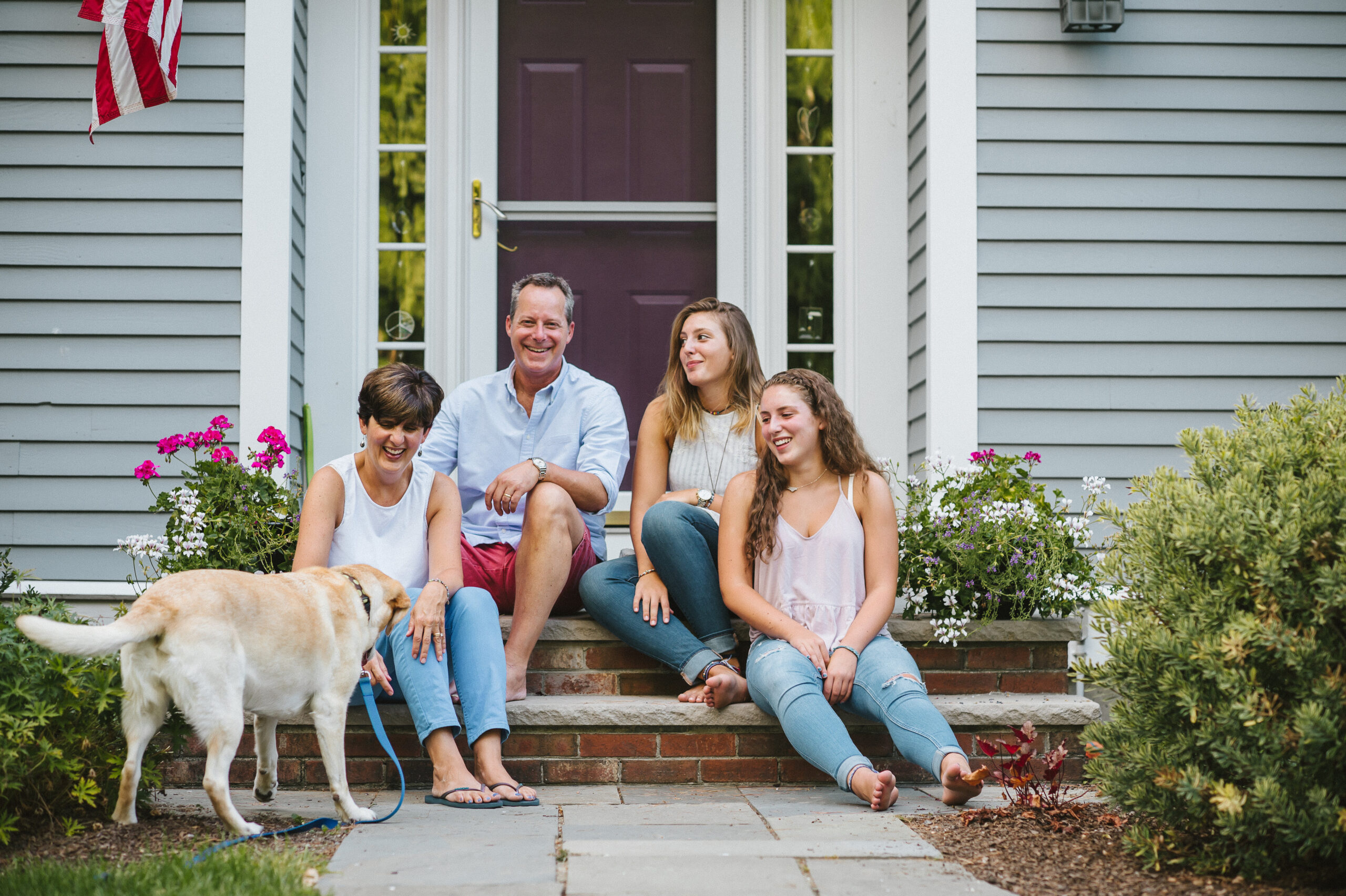 Family sitting in front of home