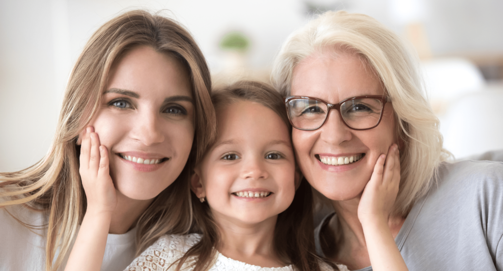 Girl smiling with her grandmother and mother. She is happy because her mother protects her with a Kids Protection Plan!