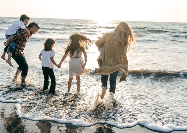 A blended family walking on the beach after they completed estate planning for non-traditional families